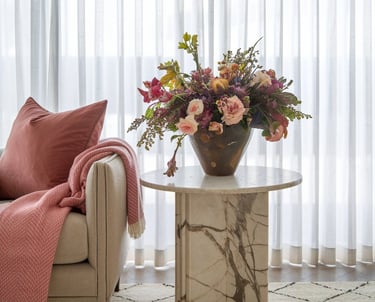 a vase with flowers in a living room