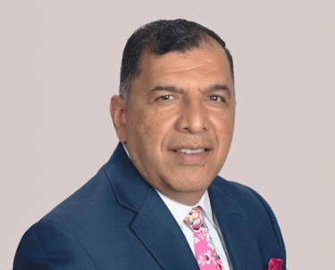 a man in a suit and tie with a pink tie