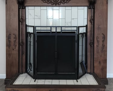 Custom wood fireplace surround with ornate carved detailing and a tiled hearth, featuring a black