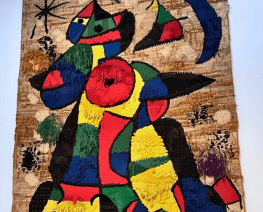 a colourful painting on a wall in the Joan Miro Museum