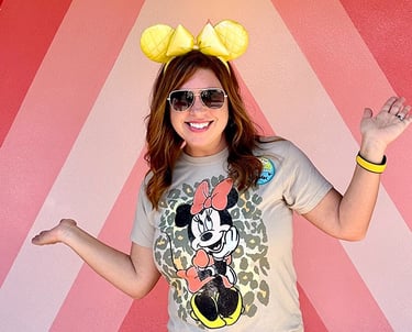 Karen Amundson in front of the "Future World" photo wall at EPCOT®.