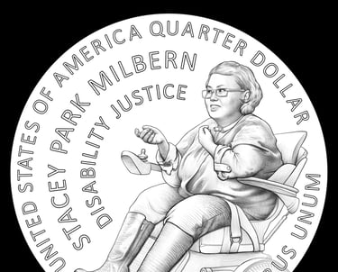 Screenshot of Stacey on the US Quarter. Her hand is facing upwards as she is speaking, her wheelchair is displayed.