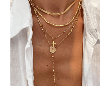 Gold layered necklace set with cross and Virgin Mary pendants.