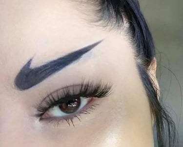 An example of unwanted permanent makeup: a woman with black Nike swoosh logos tattooed as her eyebro