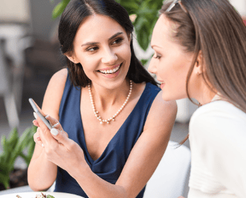 two women are sitting at a table