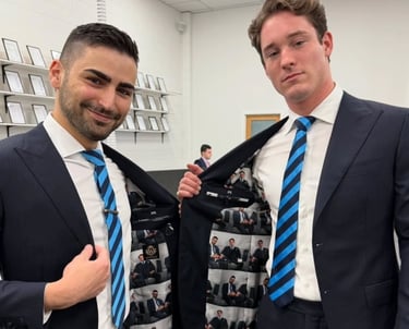 two men in suits and ties posing for a picture