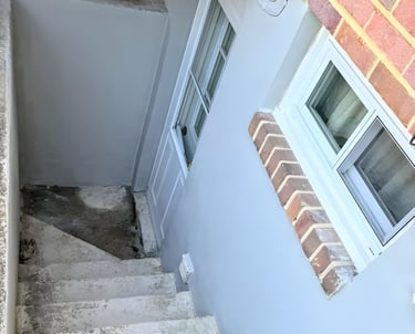 Before image of worn and uneven concrete exterior steps. 