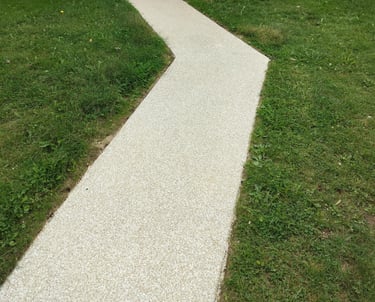Resurfaced concrete walkway with a light textured finish leading to a front porch, enhancing curb