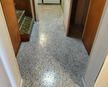 Seamless epoxy floor installed in a residential hallway and laundry room, featuring a durable flake 