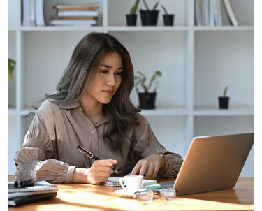 a computer user sitting at a desk learning new cybersecurity skills with Lümee awareness platform