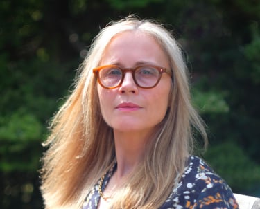 a woman with glasses and a blue dress