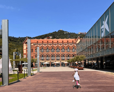 a little girl riding a scooter at cosmocaixa science museum terrace in barcelona