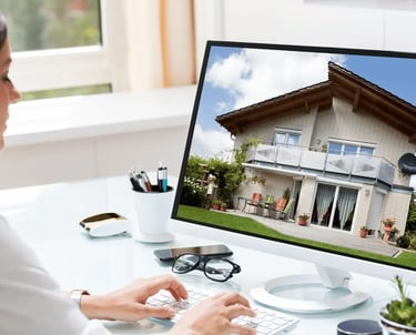 Modern home exterior and real estate listing materials on desk