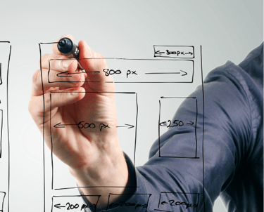 a man writing a website page plan on a whiteboard