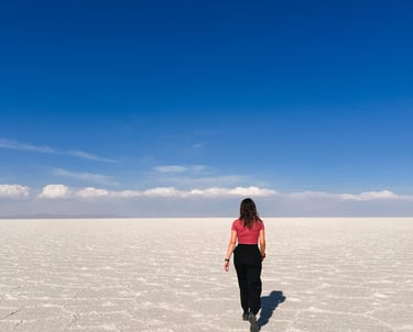 Girl in Salar de Uyuni, salt desert in Bolivia, South America