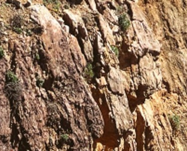 a person standing on a cliff overlooking the ocean