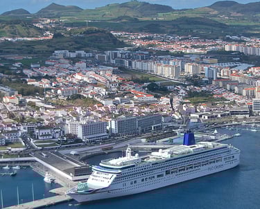 Cruise Ship in the Port of Ponta Delgada with mountains and buildings in distance