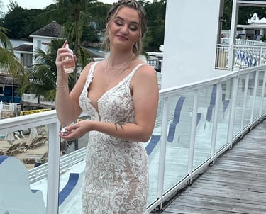 a woman in a white dress standing on a deck
