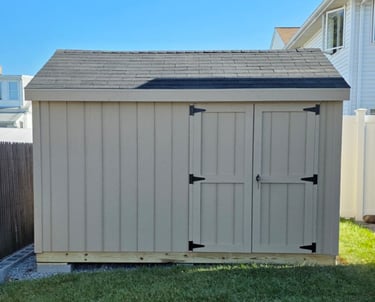 Custom 8x12 wooden shed built in Massachusetts, perfect for tools, equipment, and more.
