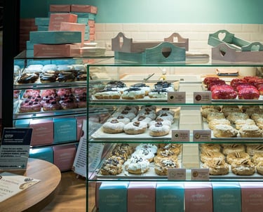 Donutería en Bratislava mostrando vitrina con donuts y pasteles variados, repostería artesanal