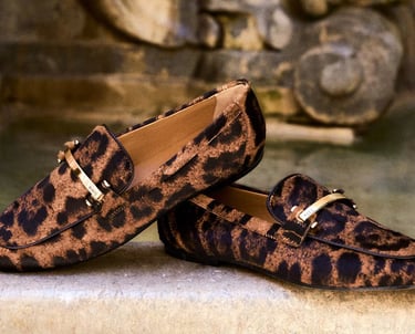Luxury leopard print loafers with gold hardware detail by Tod's.