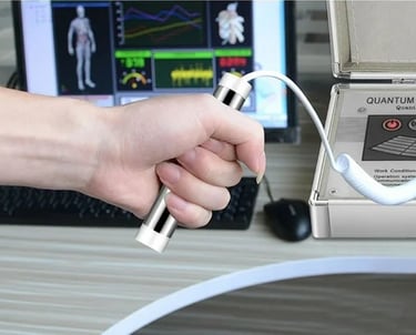 a person holding a remote control device in front of a computer