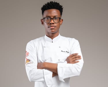 a male chef in a white uniform and glasses