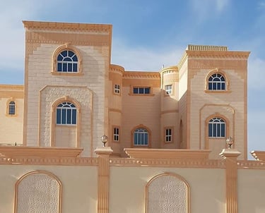 Grand villa with classical façade featuring arched windows, elegant columns, and aluminum framing.