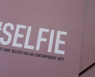 a pink book, the cover says '#Selfie: What impact have selfies had on contemporary art?'