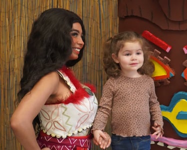 Moana poses with a child at a meet and greet