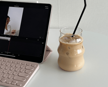 Tablet i uređivanje videozapisa, ledena kava sa slamkom na desnoj strani.