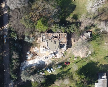 a house with a large house in the middle of a yard