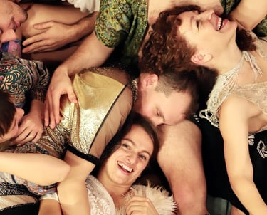a group of people laying on the floor in a cuddle puddle