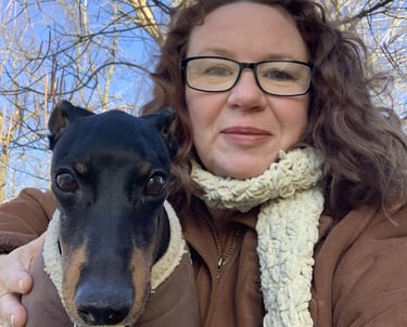 smiling woman owner in winter coat with cute dog