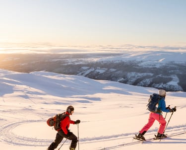 two people ski touring in the snow