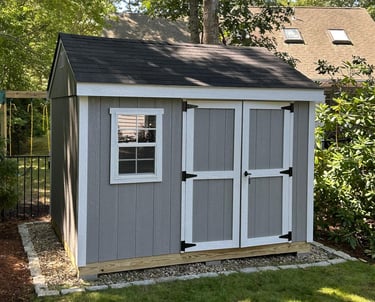 Custom 8x10 wooden shed with double doors and window, built in Halifax, Massachusetts for functional backyard storage.