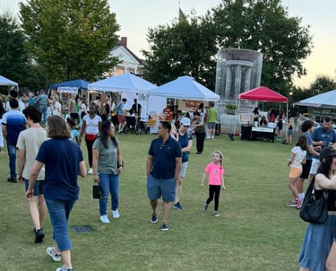 Families, kids, and community members enjoying nice weather at a market