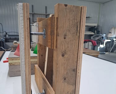 Wall assembly mock-up showing drywall and wood framing joined with metal anchor bolts for levelling demonstration