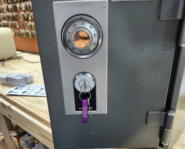 A grey safe with a purple key representing local locksmith services weaverville, NC