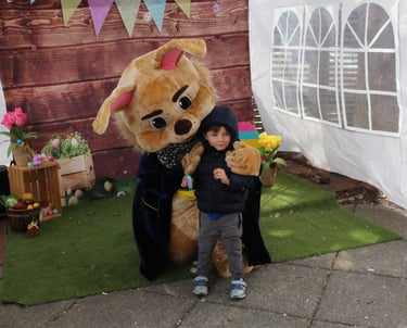 Easter Bunny shares a hug with a kid