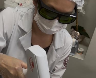 a woman is getting her laser tattoo on her leg