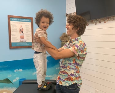 Child relaxed and smiling during pediatric chiropractic visit in Franklin Tn