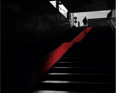 a person walking up stairs in a dark room
