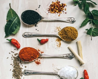 a variety of spices and spices in spoons and spoons