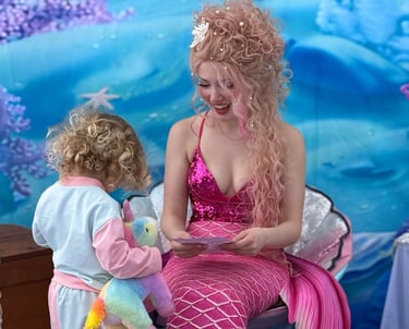 Pink mermaid shares a smile with a kid