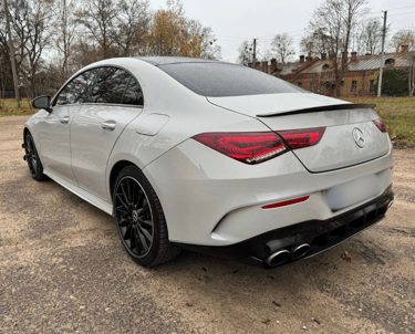 an Enlab mercedes cla parked in a parking lot