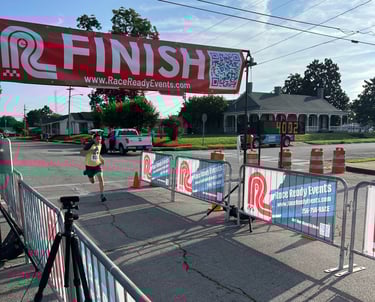 A young runner races through the finish line of a 5 Mile race in only 40 minutes, 2 seconds
