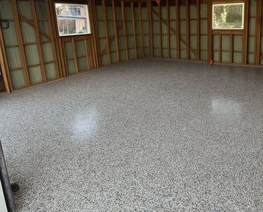 Decorative flake garage floor coating installed in residential garage