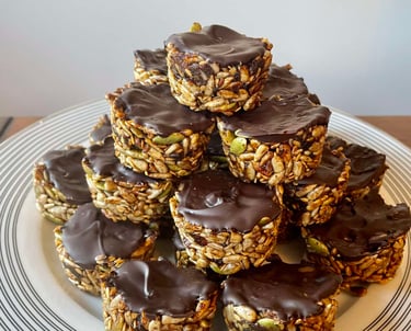 Crunchy seed bites topped with a smooth layer of Whittaker's 72% Dark Ghana Chocolate, offering a rich and indulgent treat