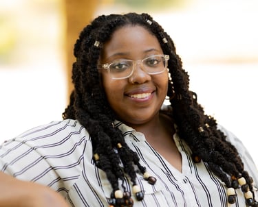 a woman with glasses and a striped shirt